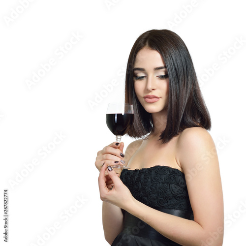 Young attractive woman holding glass of red wine. Pretty lady drinks alcoholic drink