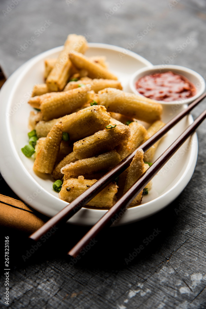 Baby Corn Manchurian dry - popular Indo-chinese starter recipe. selective focus Baby Corn Manchurian dry - popular Indo-chinese starter recipe. selective focus