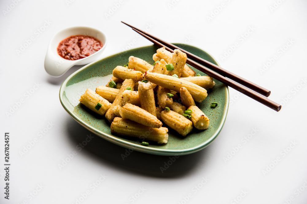 Baby Corn Manchurian dry - popular Indo-chinese starter recipe. selective focus Baby Corn Manchurian dry - popular Indo-chinese starter recipe. selective focus