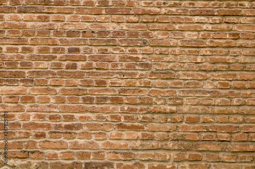 closeup of an old uneven brick wall background texture