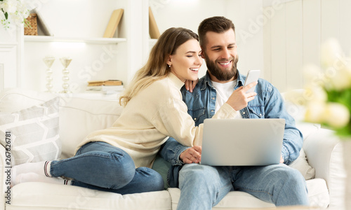 Surfing Internet. Young Couple Relaxing With Laptop