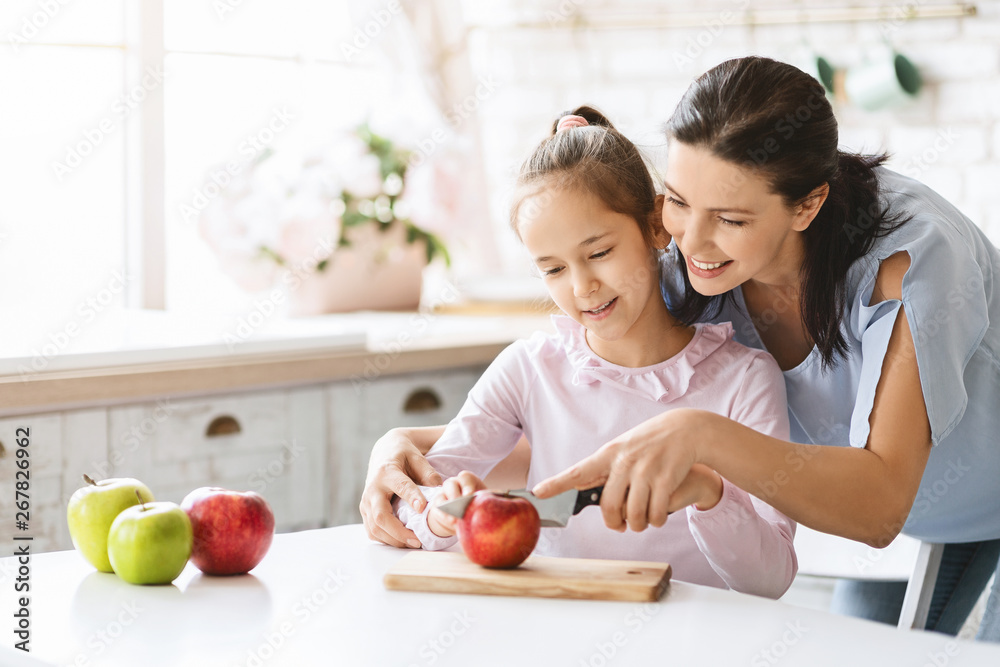 Mom Teaching Cute Girl To Cut Apple With Knife