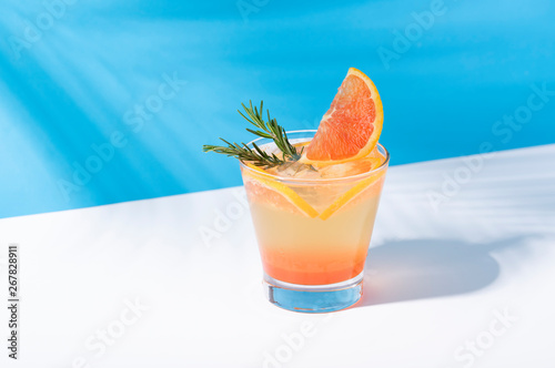 Принти на полотні Cold and refreshing orange punch cocktail with orange slice on color background