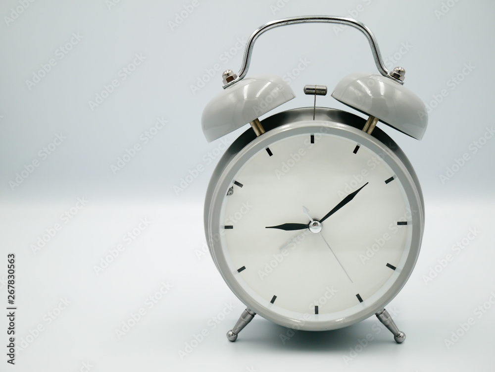 White retro with silver border alarm clock that represent number of analog on isolated white background White retro with silver border alarm clock that represent number of analog on isolated white background