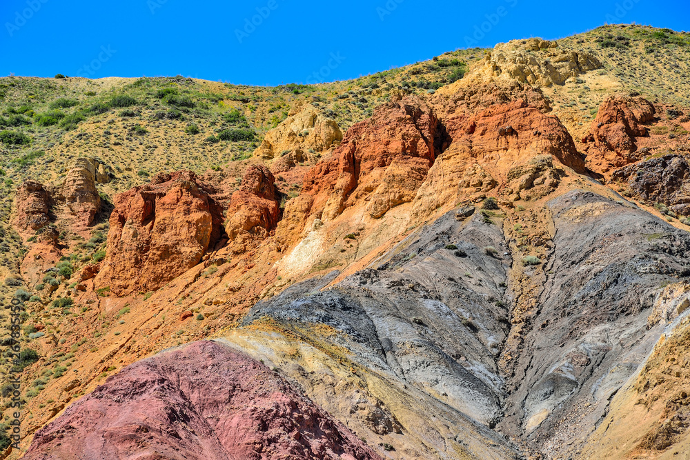 Fototapeta premium Texture of unrealy beautiful colorful clay cliffs in Altai mountains, Russia