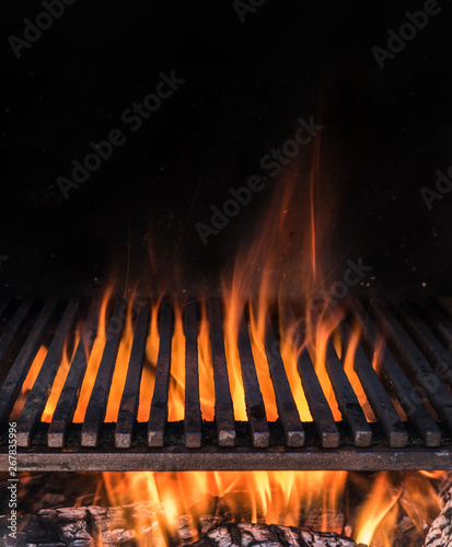 Empty grill grate and tongues of fire flame. Barbeque night background.