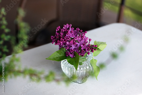 Bouquet of lilac in purple in glass vase