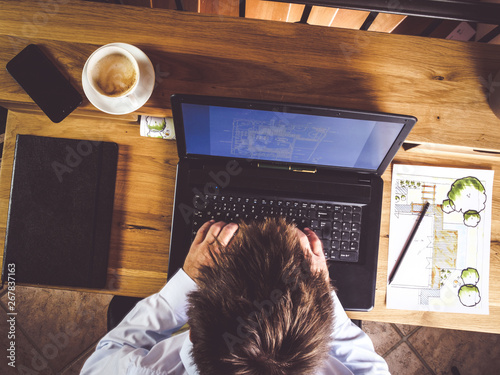 top view of businessman working on laptop at home office