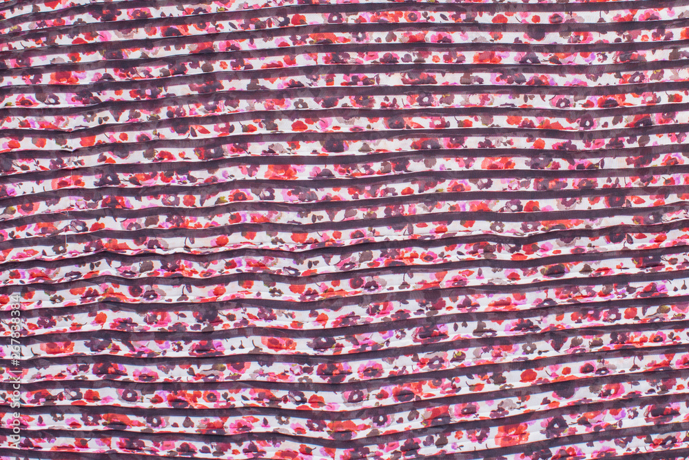 accordion folded fabric with floral pattern, on the folds of black color accordion folded fabric with floral pattern, on the folds of black color