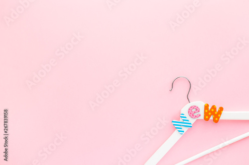 White hangers with sale text on pink background