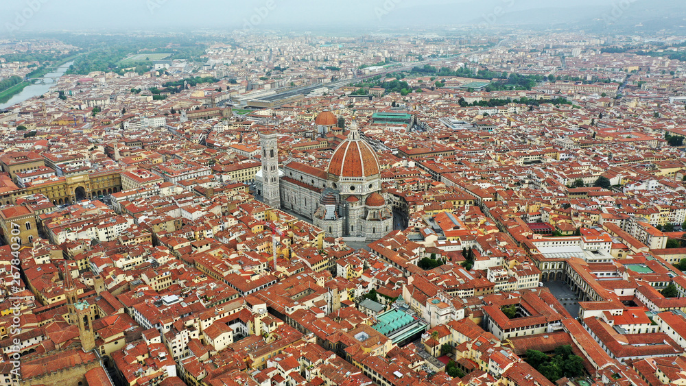 Aerial view of Santa Maria del Fiore Cathedral in Florence, Italy. Orange roofs, hills. Italian Tuscany landscape.