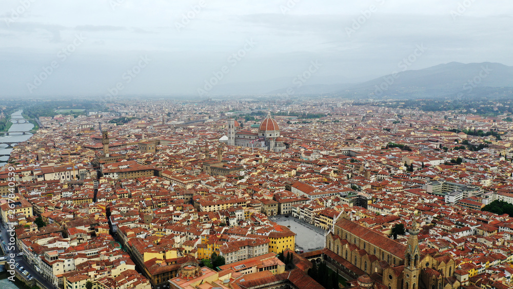 Obraz premium Aerial view of Santa Maria del Fiore Cathedral in Florence, Italy. Orange roofs, hills. Italian Tuscany landscape.