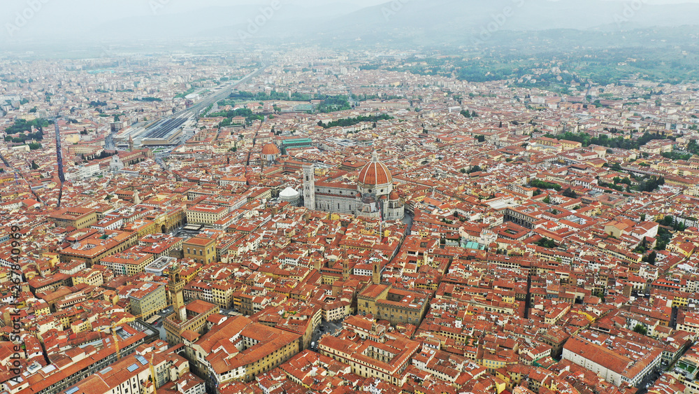 Obraz premium Aerial view of Santa Maria del Fiore Cathedral in Florence, Italy. Orange roofs, hills. Italian Tuscany landscape.
