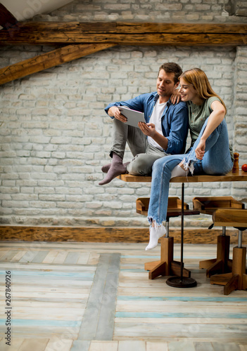 Young couple is using a dig...