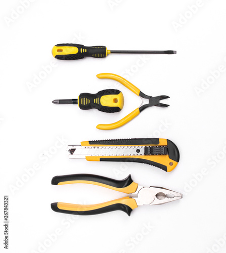 Black yellow tools - knife, pliers, tape measure, screwdriver, nippers on a white background. Place for text. Work inventory