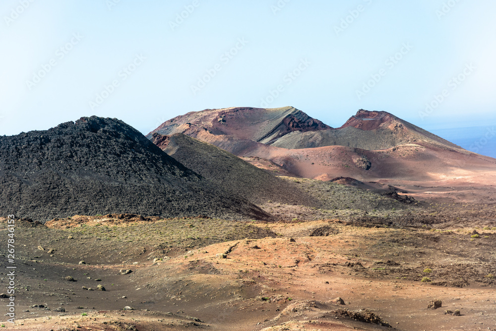 Timanfaya National Park, mountains of fire at Lanzarote, Canary Islands, Spain. Unique panoramic view of spectacular  huge volcano cones crater.