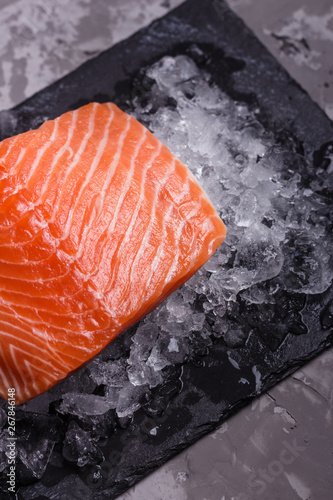 chilled salmon fillet on a gray stone background