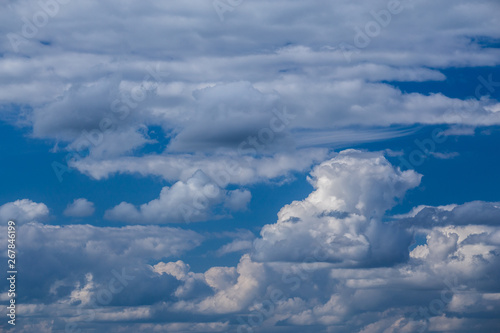 Regular spring clouds on blue sky at daylight in continental europe. Shot wit telehoto lens and polarizing filter. photo