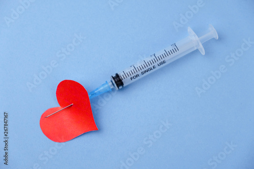 heart shape pierced with syringe