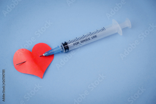 heart shape pierced with syringe