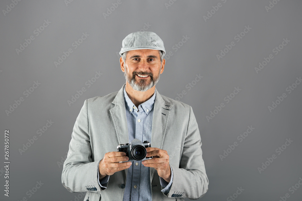 middle aged man in casual suit holding camera middle aged man in casual suit holding camera