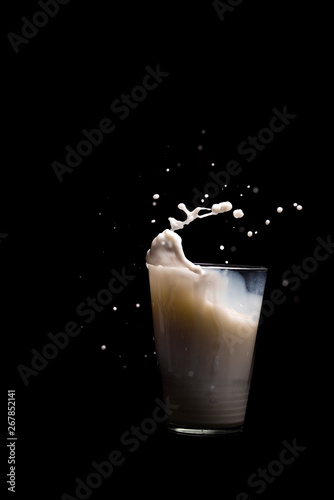 Milk glass splash isolated on black background