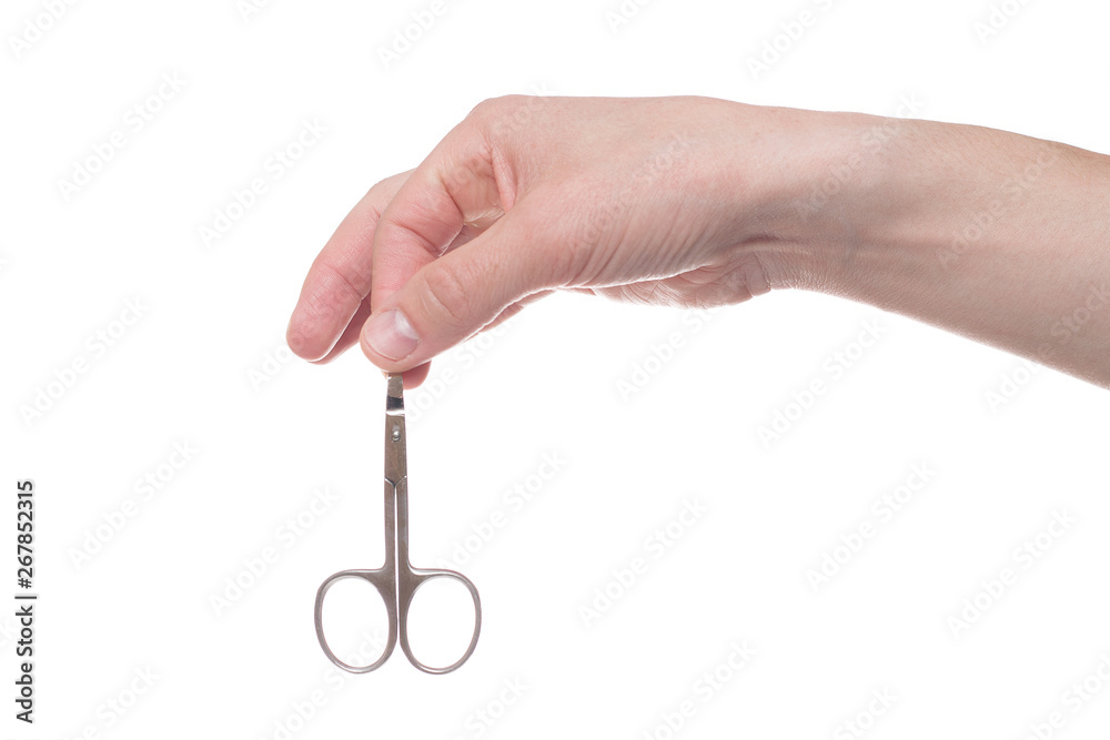Hand holding scissors for manicure isolated on white background. Health and personal care conception. Hand holding scissors for manicure isolated on white background. Health and personal care conception.