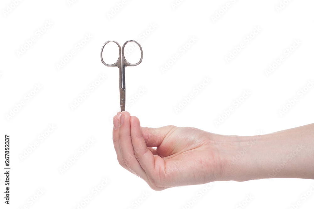 Hand holding scissors for manicure isolated on white background. Health and personal care conception. Hand holding scissors for manicure isolated on white background. Health and personal care conception.