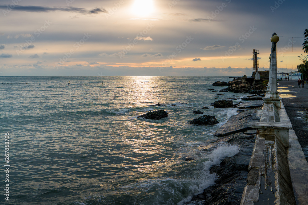 Seascape of the black sea coast overlooking the ruins of the fortress dioskuria in the evening sunset. Abkhazia. Sukhumi. Seascape of the black sea coast overlooking the ruins of the fortress dioskuria in the evening sunset. Abkhazia. Sukhumi.