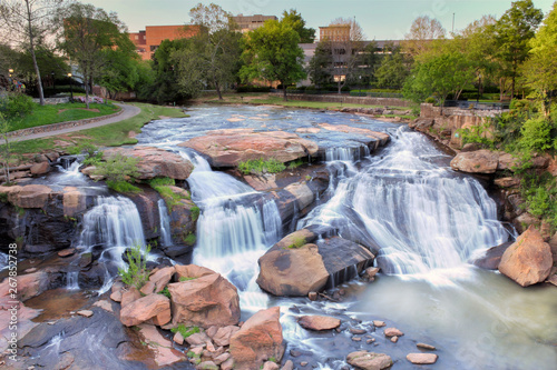 View from the Liberty bridge at a beautiful waterfall in the middle of Greenville South Carolina Falls park in the downtown. 