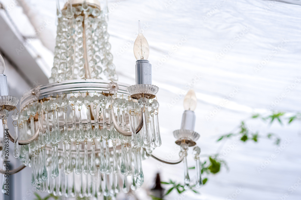 Antique vintage crystal chandelier in rustic style close up and copy space