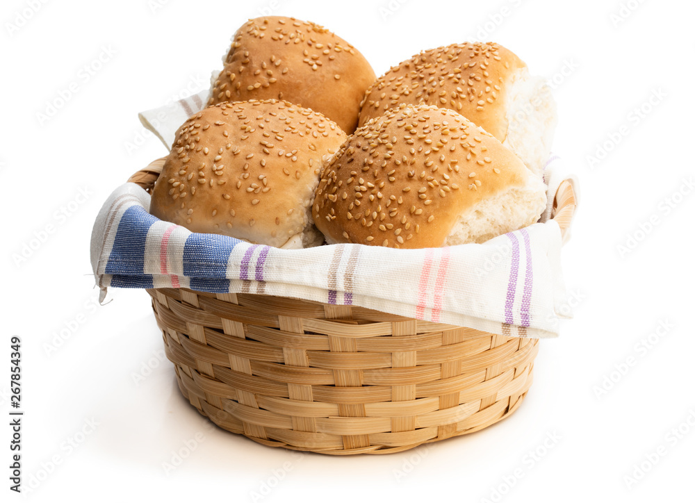 Group of sesame seeded hamburger buns in wicker basket isolated on a white Group of sesame seeded hamburger buns in wicker basket isolated on a white