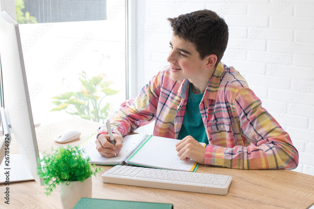 young student with computer on home desk or school young student with computer on home desk or school