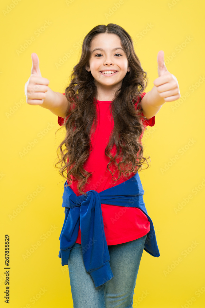 Perfect curls. Kid cute face with adorable curly hairstyle. Little girl  grow long hair. Teen fashion