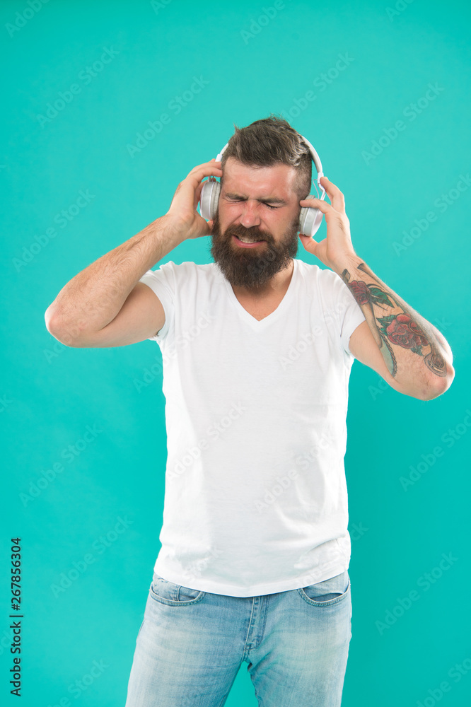 Man in headphones. Free online music sources all work little bit differently and have many different features. Music chart. Mature hipster with beard listening music. Stylish and handsome music lover Man in headphones. Free online music sources all work little bit differently and have many different features. Music chart. Mature hipster with beard listening music. Stylish and handsome music lover