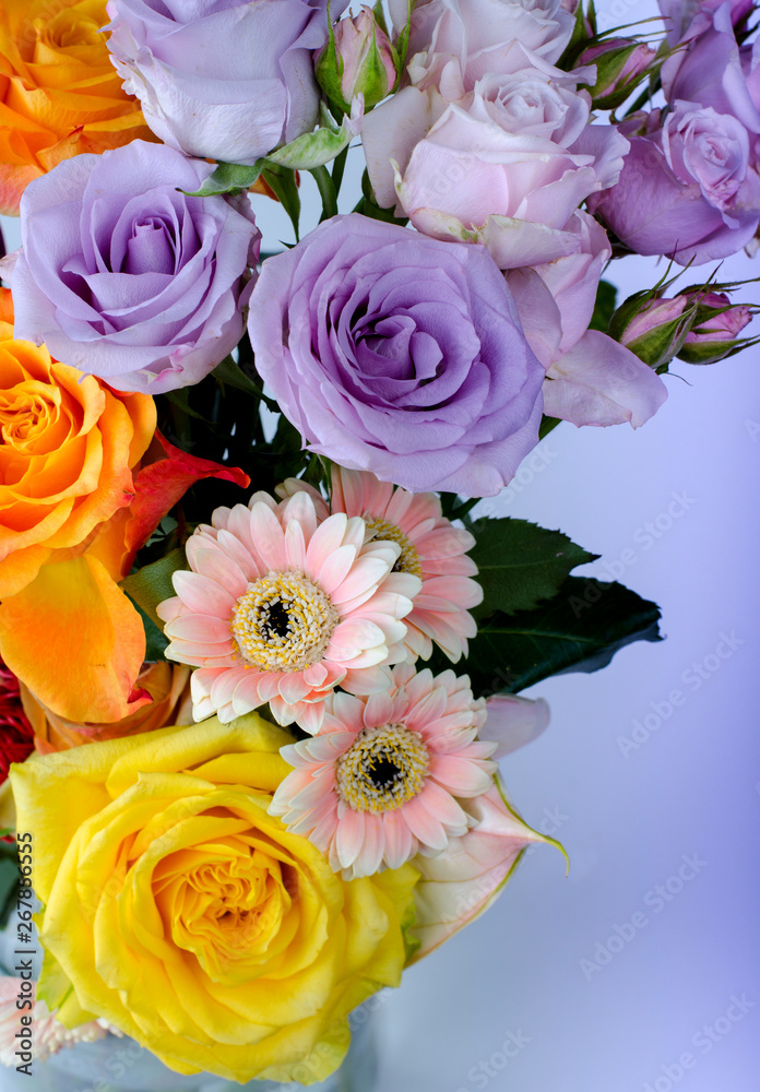 Various flowers bouquet. Pink Gerberas and gentle lilac roses close up floral background. Various flowers bouquet. Pink Gerberas and gentle lilac roses close up floral background.
