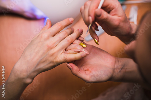 A woman makes a manicure. Salon treatments at home. close-up