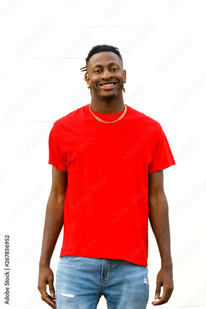 African American Teen Male wearing a red t-shirt and jeans Smiling ...