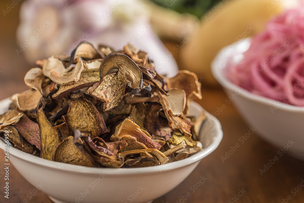 Dried mushrooms sour cabbage garlic and potatoes on wooden table Dried mushrooms sour cabbage garlic and potatoes on wooden table