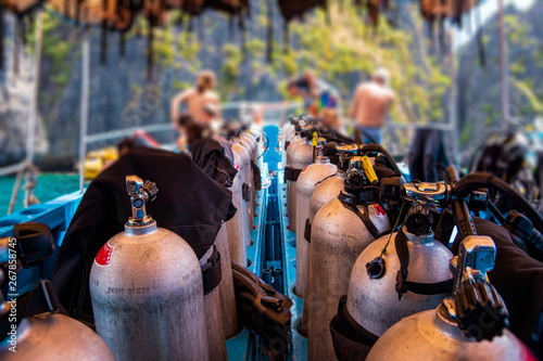 Scuba divers getting ready for diving on a boat full of equipment, Thailand photo