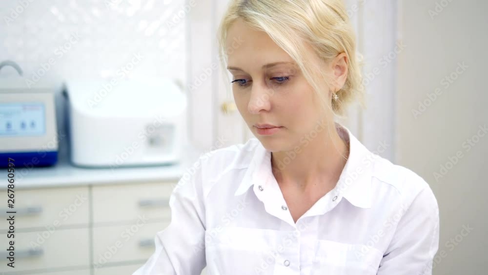 woman A doctor prepares a solution from a vial of a vaccine with a drug and fills a syringe for vaccinating patients in a medical clinic. woman A doctor prepares a solution from a vial of a vaccine with a drug and fills a syringe for vaccinating patients in a medical clinic.