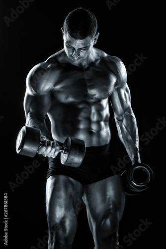 Handsome Bodybuilder Lifting Weights. Execising With Dumbbells  Performing Dumbbell Biceps Curls