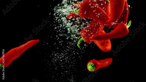 red pepper falls under the water, slow motion
