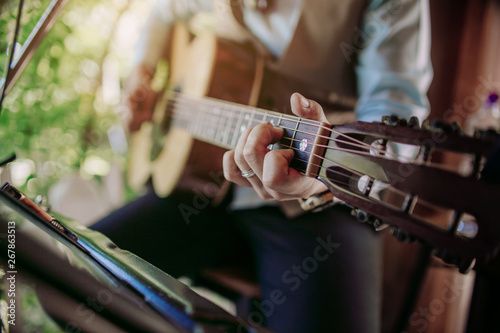 Musician playing guitar at a party.
