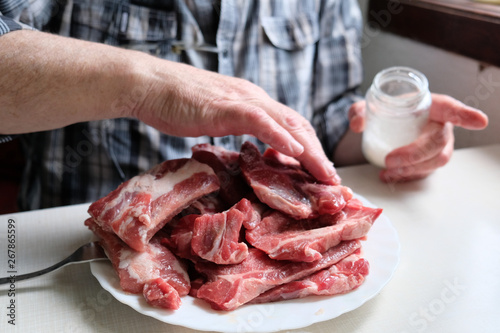 Chef salting raw meat