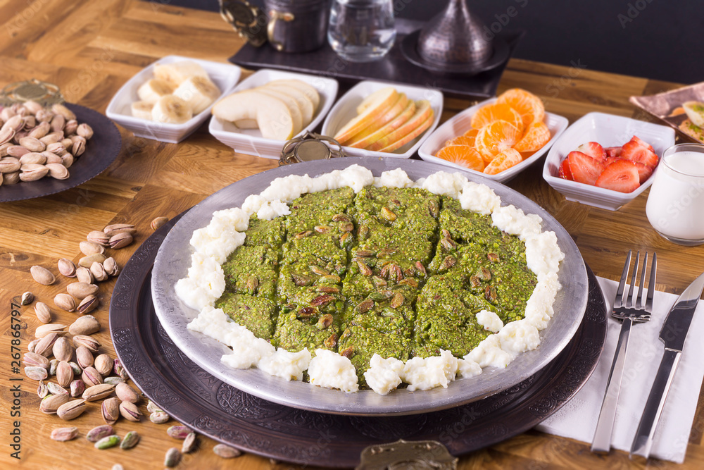 Turkish dessert kunefe, kunafa, kadayif with pistachio powder and cheese hot eaten a sweet Turkish dessert kunefe, kunafa, kadayif with pistachio powder and cheese hot eaten a sweet