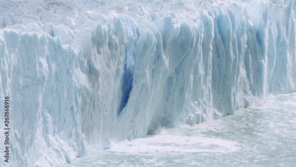 Chunk of glacier collapsing into the lake Argentino on the patagonian region. Slow motion.