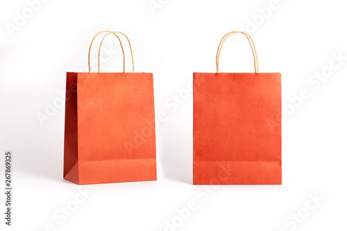 Orange paper bags isolated on white background.