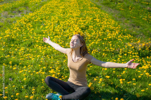 young beautiful girl among yellow dandelions, full-length portrait,