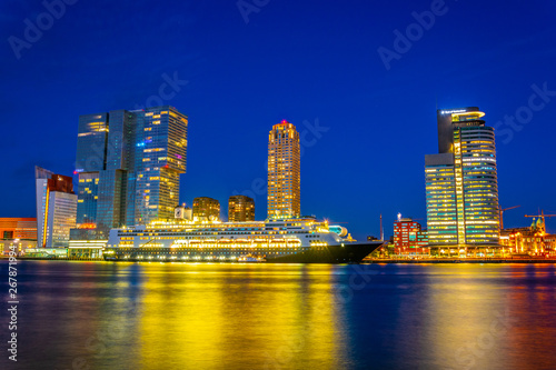 Night view of Holland america line building and other skyscrapers in Rotterdam, Netherlands photo